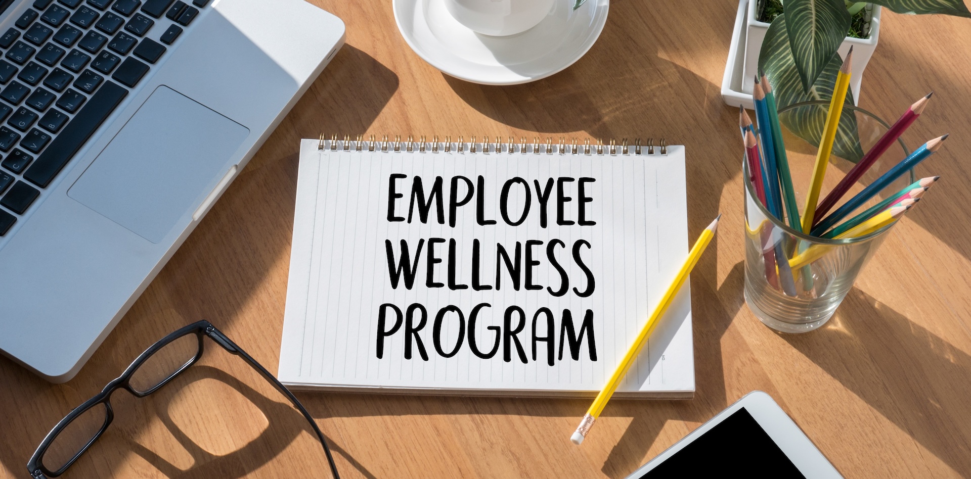 Employee wellness programme notepad on an office desk